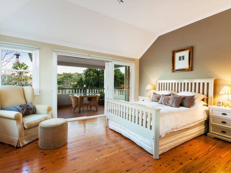 Country bedroom design idea with floorboards & balcony ...