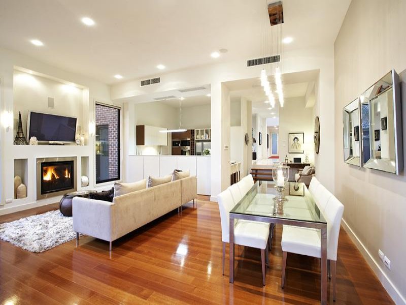 Dining-living living room using white colours with floorboards ...